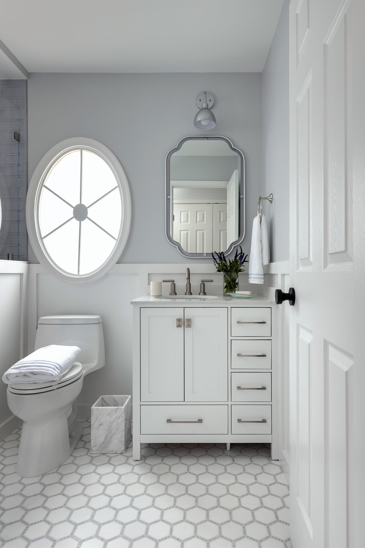 Willowgate powder room with statement tile and wall-mounted fixtures